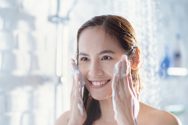 mujer que se lava el rostro con frecuencia porque tiene problemas en la piel